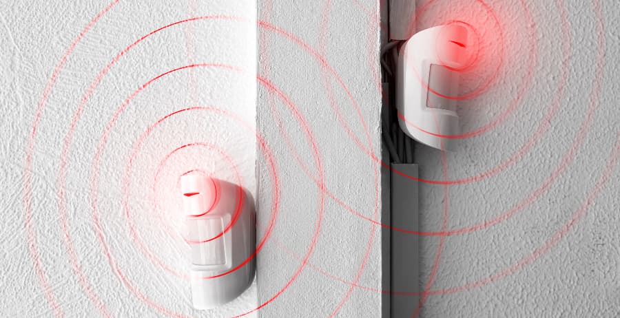 Modern motion sensors attached to walls in a home